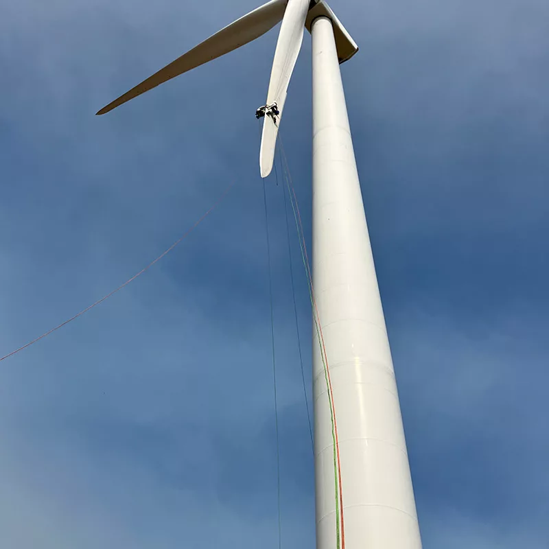 Rope access technicians completing wind turbine blade maintenance